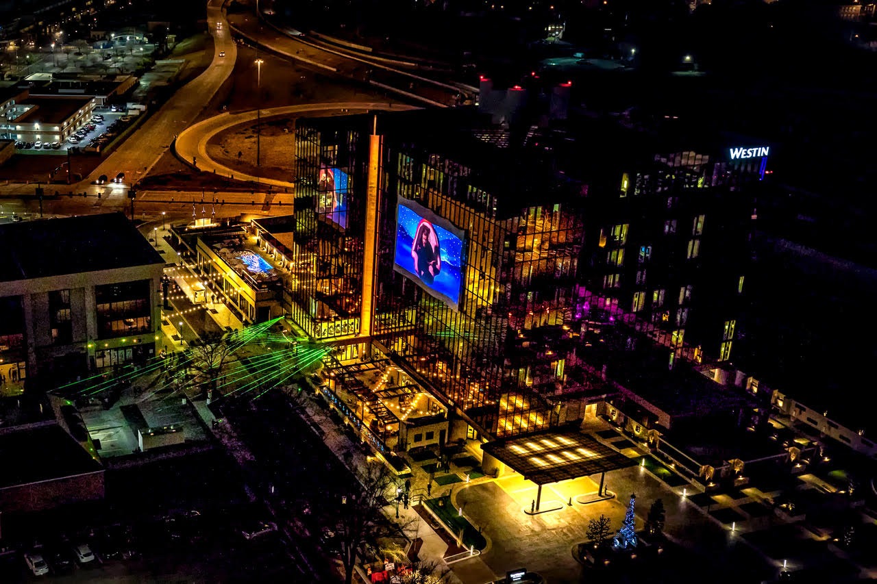 An aerial view of the West Village area of downtown Chattanooga, where Easy Bistro restaurant is located, at night.